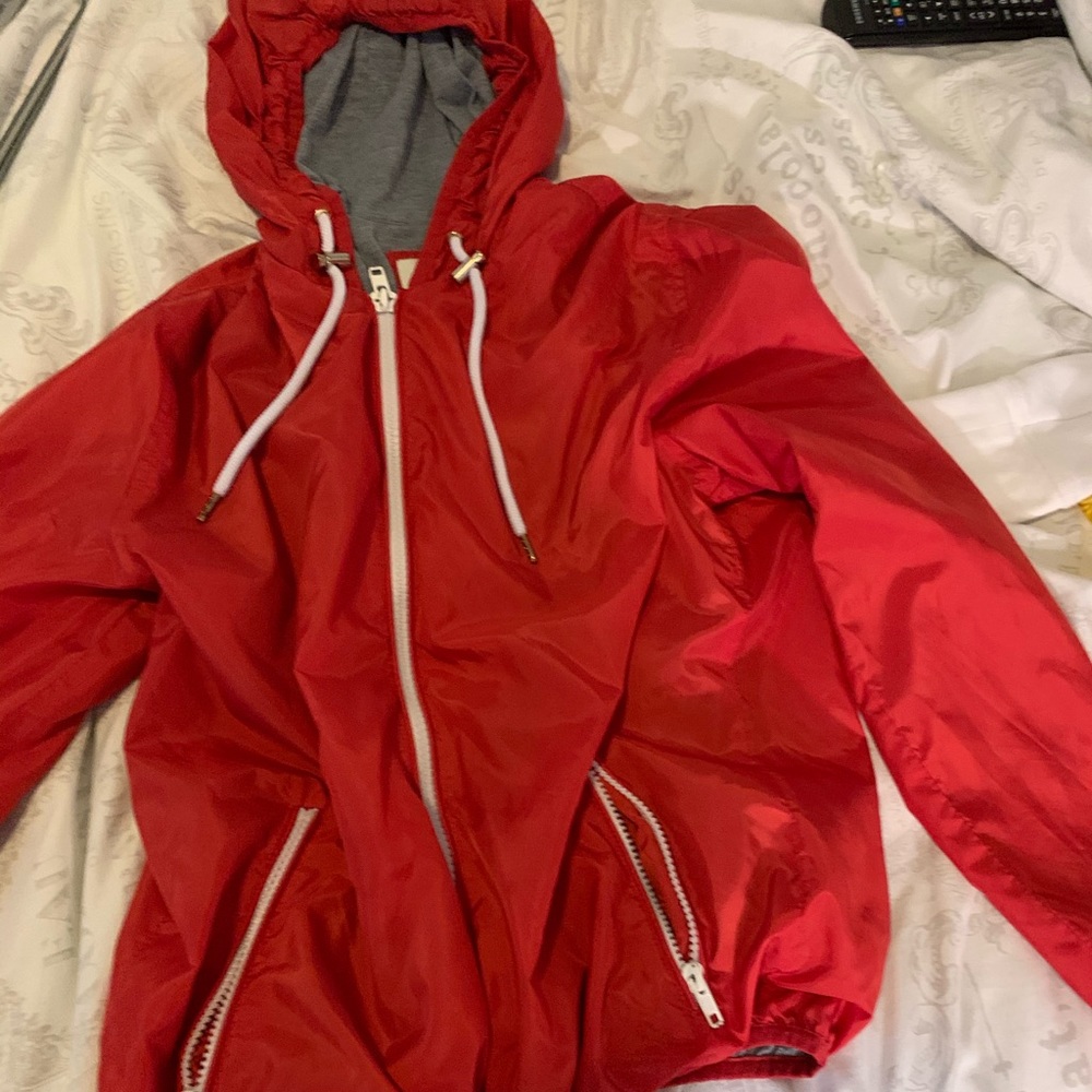 Red windbreaker.